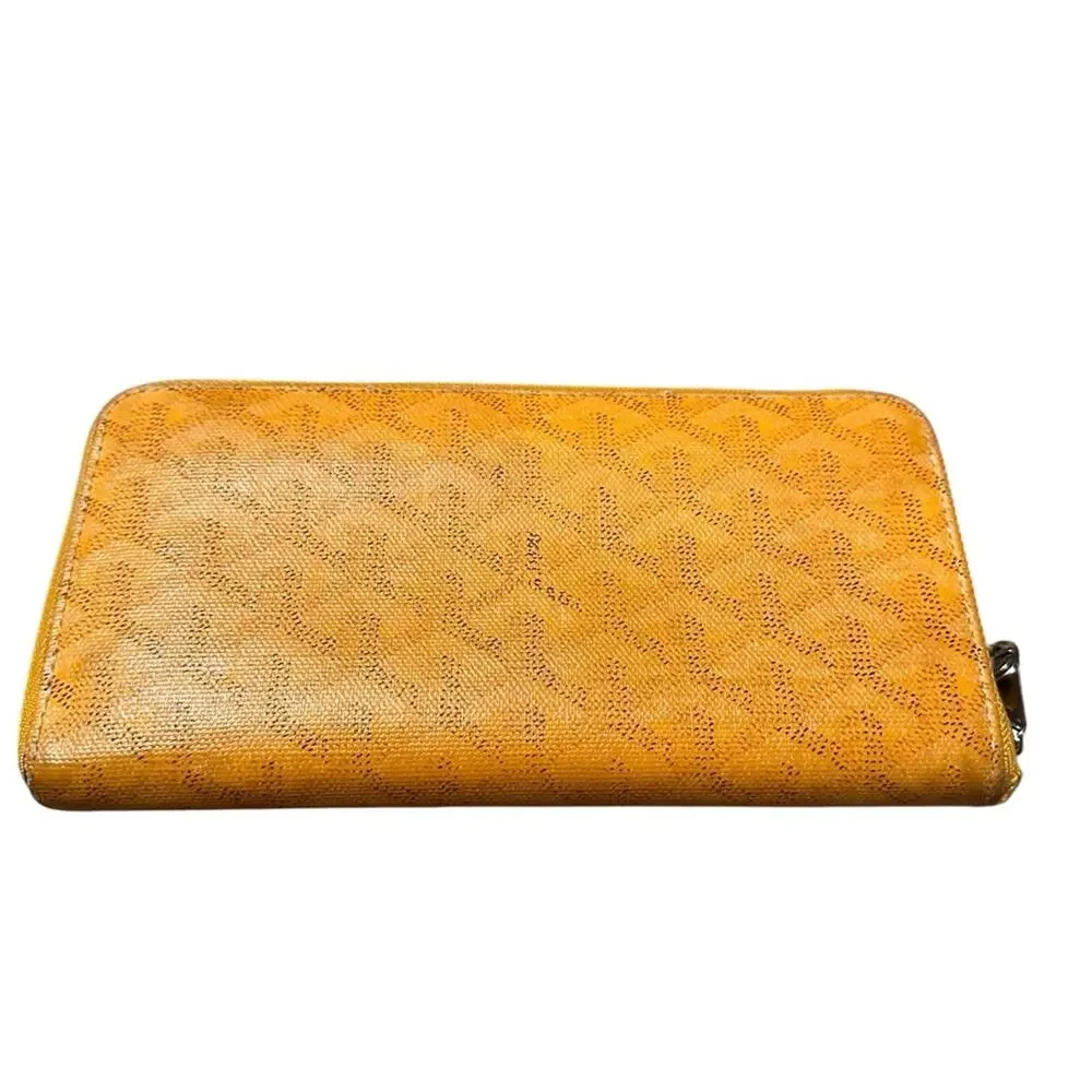Goyard Matignon zip-around wallet in yellow orange Goyardine canvas.
